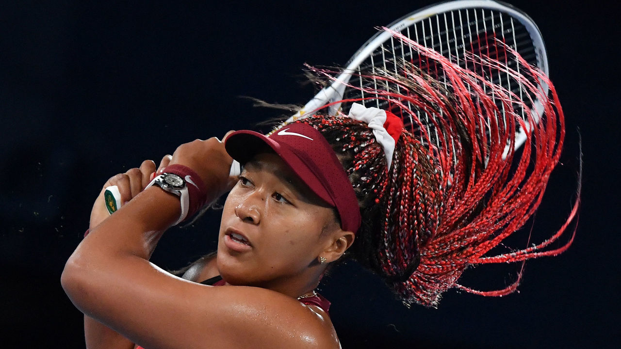 Japan's Naomi Osaka returns the ball to Czech Republic's Marketa Vondrousova during their Tokyo 2020 Olympic Games women's singles third round tennis match at the Ariake Tennis Park in Tokyo on July 27, 2021.