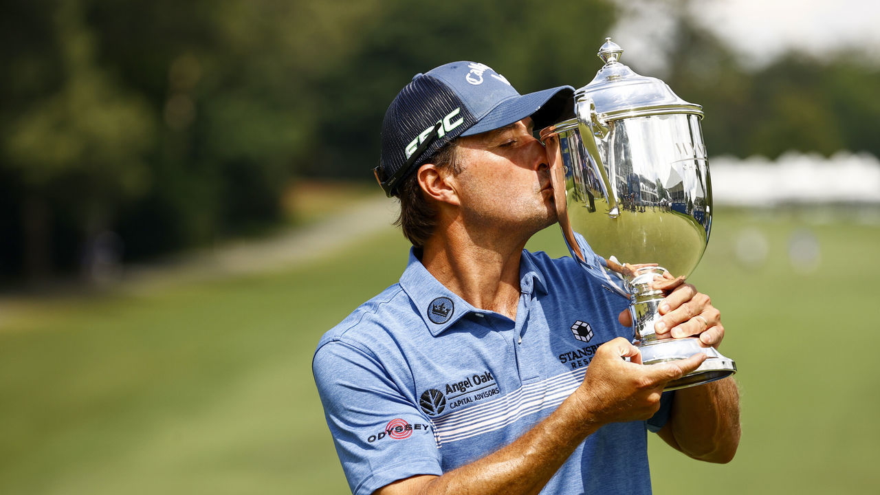 GREENSBORO, NORTH CAROLINA - AUGUST 15: Kevin Kisner of the United States celebrates with the trophy after winning a 6-way sudden-death playoff during the final round of the Wyndham Championship at Sedgefield Country Club on August 15, 2021 in Greensboro, North Carolina.