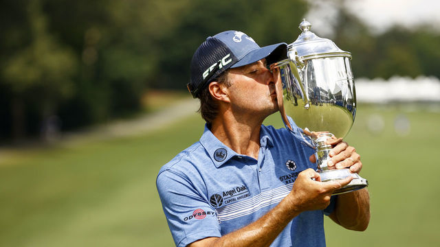 GREENSBORO, NORTH CAROLINA - AUGUST 15: Kevin Kisner of the United States celebrates with the trophy after winning a 6-way sudden-death playoff during the final round of the Wyndham Championship at Sedgefield Country Club on August 15, 2021 in Greensboro, North Carolina.