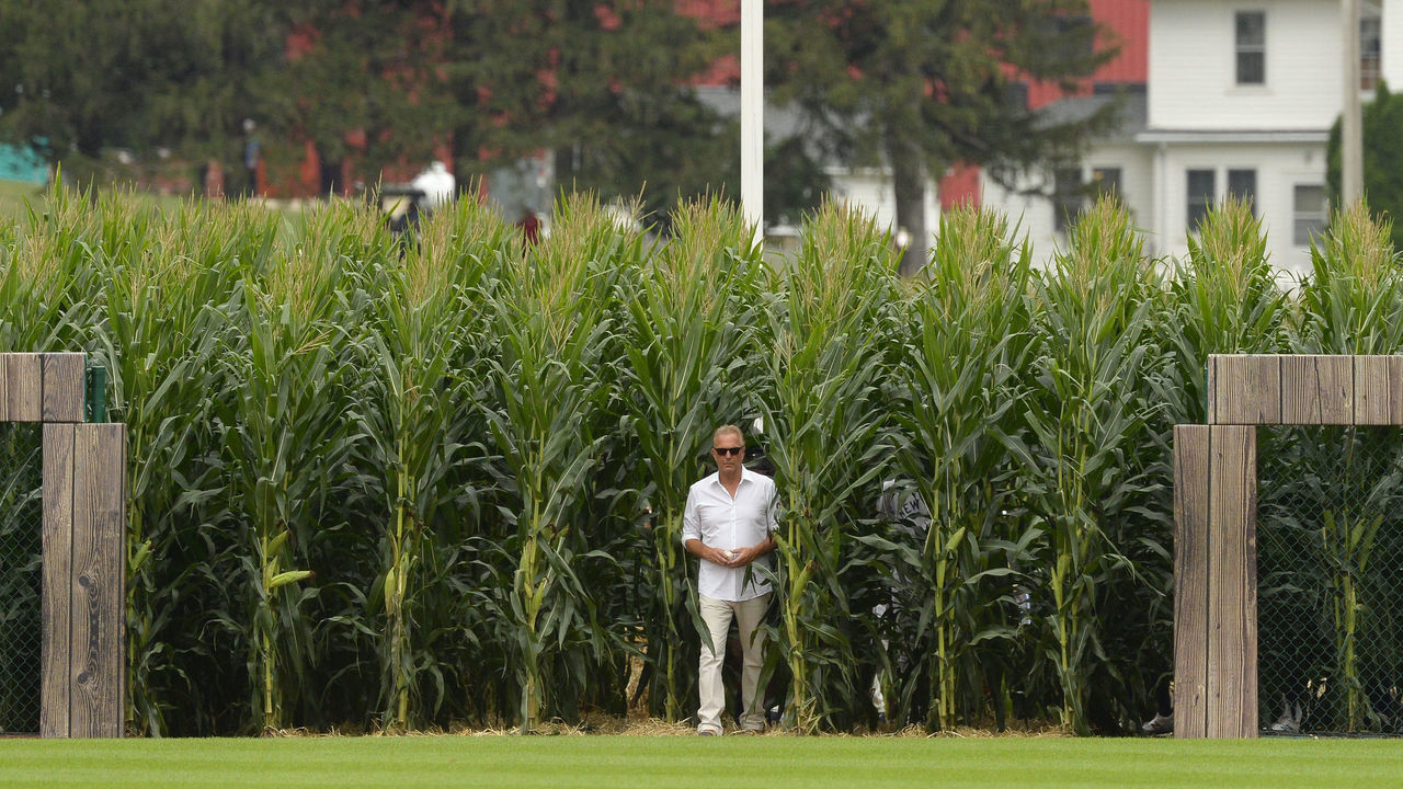 CHICAGO - AUGUST 12: Actor Kevin Costner walks through the corn rows while being introduced prior to the game between the Chicago White Sox and New York Yankees on August 12, 2021 at Field of Dreams in Dyersville, Iowa.
