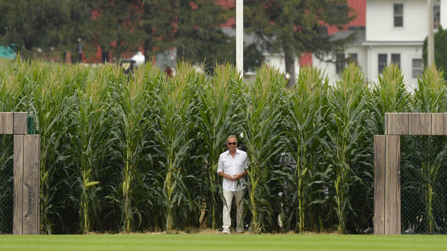 CHICAGO - AUGUST 12: Actor Kevin Costner walks through the corn rows while being introduced prior to the game between the Chicago White Sox and New York Yankees on August 12, 2021 at Field of Dreams in Dyersville, Iowa.