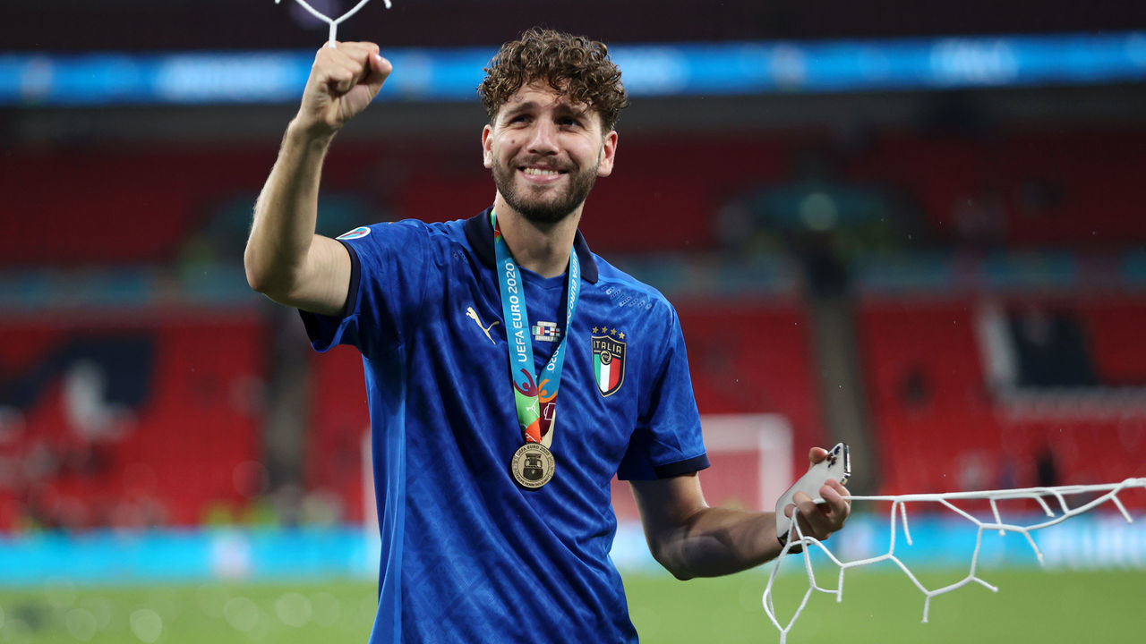 LONDON, ENGLAND - JULY 11: Manuel Locatelli of Italy cuts the net following victory in the UEFA Euro 2020 Championship Final between Italy and England at Wembley Stadium on July 11, 2021 in London, England.