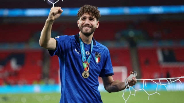 LONDON, ENGLAND - JULY 11: Manuel Locatelli of Italy cuts the net following victory in the UEFA Euro 2020 Championship Final between Italy and England at Wembley Stadium on July 11, 2021 in London, England.