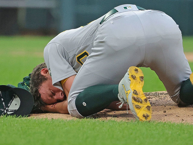 CHICAGO, ILLINOIS - AUGUST 17: Starting pitcher Chris Bassitt #40 of the Oakland Athletics lies on the ground after being hit in the head by a line drive from Brian Goodwin of the Chicago White Sox in the second inning at Guaranteed Rate Field on August 17, 2021 in Chicago, Illinois.