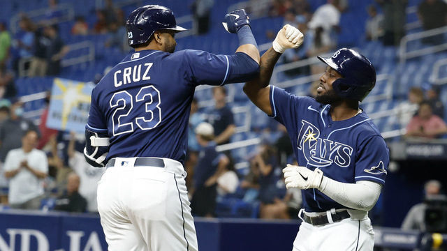 ST PETERSBURG, FLORIDA - AUGUST 17: Nelson Cruz #23 of the Tampa Bay Rays celebrates with Randy Arozarena #56 after hitting a two run home run during the sixth inning against the Baltimore Orioles at Tropicana Field on August 17, 2021 in St Petersburg, Florida.