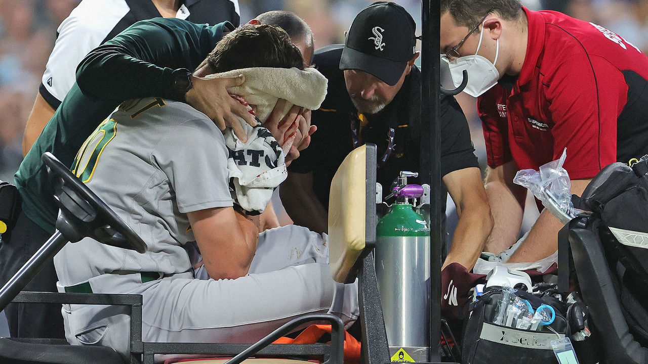 CHICAGO, ILLINOIS - AUGUST 17: Starting pitcher Chris Bassitt #40 of the Oakland Athletics is placed on a cart after being hit in the head by a line drive from Brian Goodwin of the Chicago White Sox in the second inning at Guaranteed Rate Field on August 17, 2021 in Chicago, Illinois.