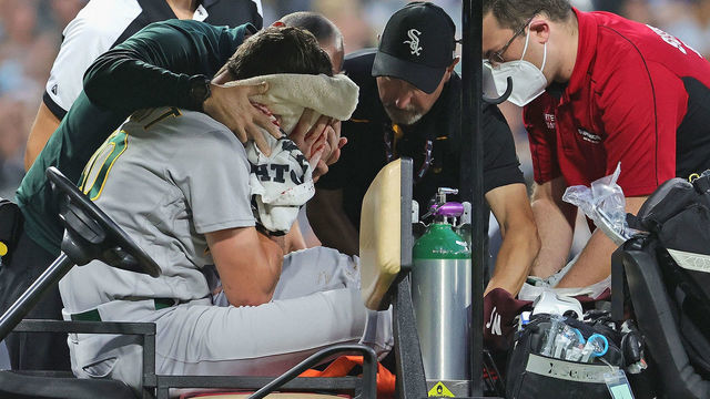 CHICAGO, ILLINOIS - AUGUST 17: Starting pitcher Chris Bassitt #40 of the Oakland Athletics is placed on a cart after being hit in the head by a line drive from Brian Goodwin of the Chicago White Sox in the second inning at Guaranteed Rate Field on August 17, 2021 in Chicago, Illinois.