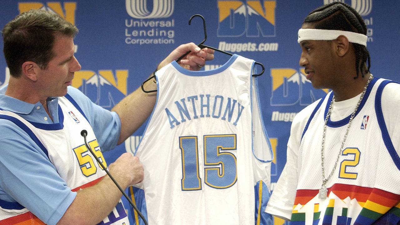 DENVER CO., JUNE 27, 2003 - Denver Nuggets General Manager KiKi <cq> Vandeweghe <cq>, left, hands the Nuggets uniform to Carmelo <cq> Anthony <cq> from Syracuse University with Denver Nuggets first pick (third overall) in NBA Draft 2003 at Pepsi Center on Friday afternoon. (THE DENVER POST PHOTO BY HYOUNG CHANG)