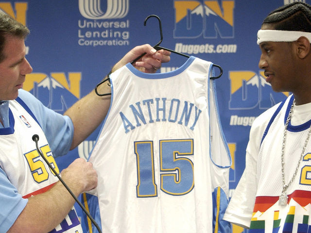 DENVER CO., JUNE 27, 2003 - Denver Nuggets General Manager KiKi <cq> Vandeweghe <cq>, left, hands the Nuggets uniform to Carmelo <cq> Anthony <cq> from Syracuse University with Denver Nuggets first pick (third overall) in NBA Draft 2003 at Pepsi Center on Friday afternoon. (THE DENVER POST PHOTO BY HYOUNG CHANG)
