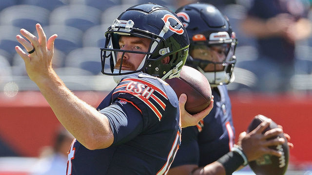 CHICAGO, ILLINOIS - AUGUST 14: Andy Dalton #14 and Justin Fields #1 of the Chicago Bears participate in warm-ups before a preseason game against the Miami Dolphins at Soldier Field on August 14, 2021 in Chicago, Illinois. The Bears defeated the Dolphins 20-13.