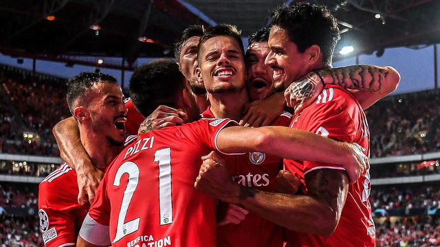 Benfica's German midfielder Julian Weigl (C) celebrates with teammates scoring Benfica's second goal during the UEFA Champions League play-off first leg football match between Benfica and PSV Eindhoven at the Luz stadium in Lisbon on August 18, 2021.