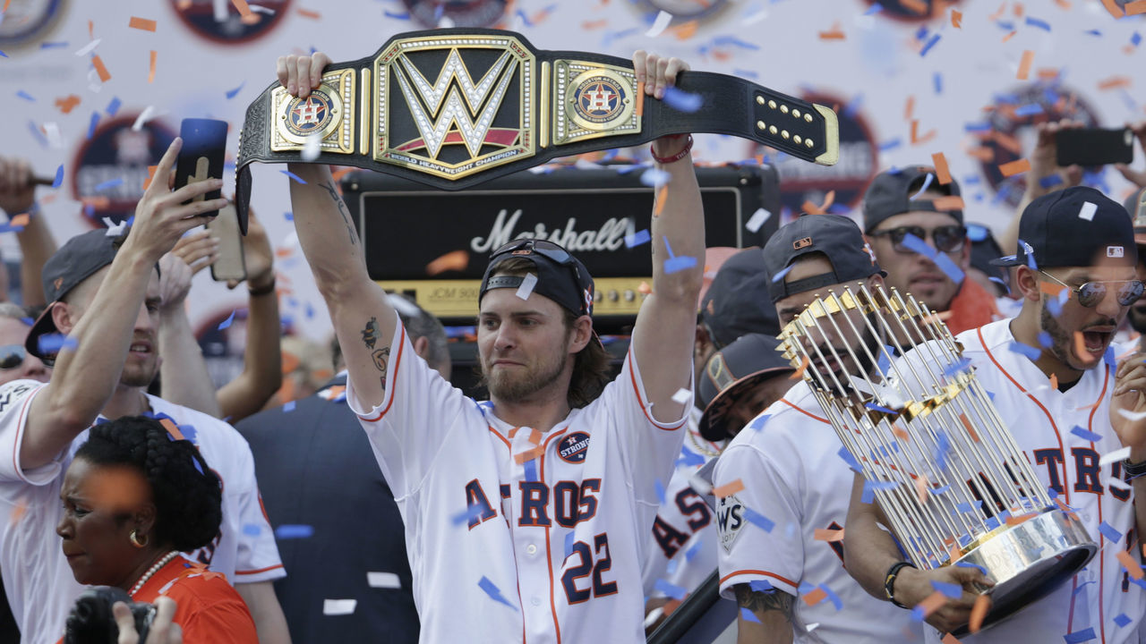 HOUSTON, TX - NOVEMBER 03: Josh Reddick #22 of the Houston Astros celebrates with a belt as Carlos Correa #1 holds the World Series Trophy during the Houston Astros Victory Parade on November 3, 2017 in Houston, Texas. The Astros defeated the Los Angeles Dodgers 5-1 in Game 7 to win the 2017 World Series.