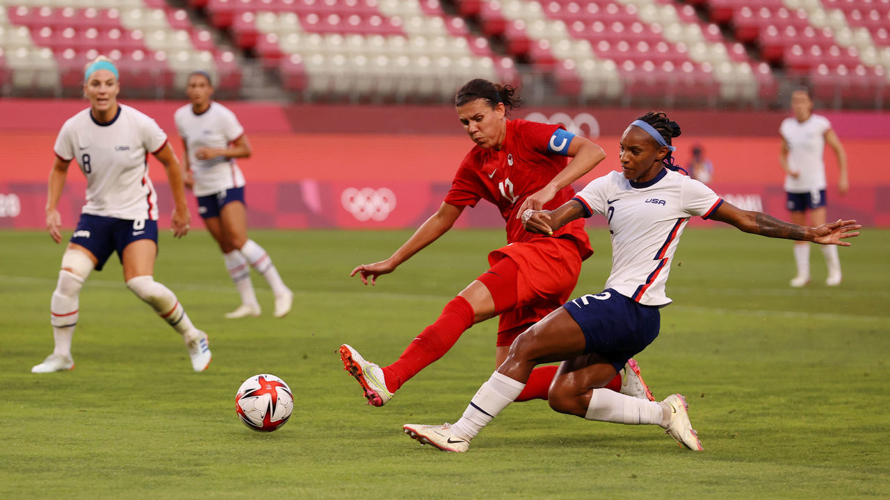 KASHIMA, JAPAN - AUGUST 02: Crystal Dunn #2 of Team United States shoots whilst under pressure from Christine Sinclair #12 of Team Canada during the Women's Semi-Final match between USA and Canada on day ten of the Tokyo Olympic Games at Kashima Stadium on August 02, 2021 in Kashima, Ibaraki, Japan.