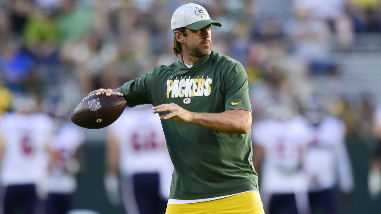 GREEN BAY, WISCONSIN - AUGUST 14: Aaron Rodgers #12 of the Green Bay Packers throws a pass during warmups before the preseason game against the Houston Texans at Lambeau Field on August 14, 2021 in Green Bay, Wisconsin.