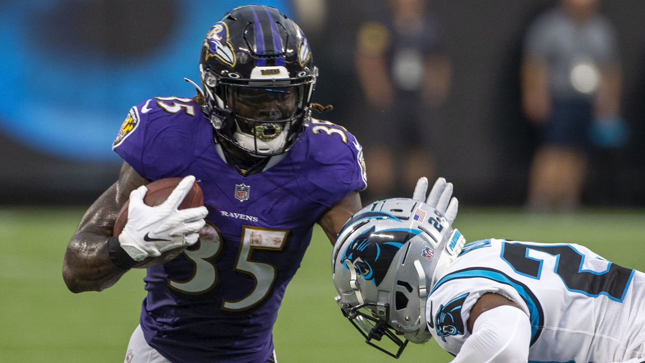 CHARLOTTE, NC - AUGUST 21: Gus Edwards #35 of the Baltimore Ravens runs the ball against the Carolina Panthers during the first half of a NFL preseason game at Bank of America Stadium on August 21, 2021 in Charlotte, North Carolina.