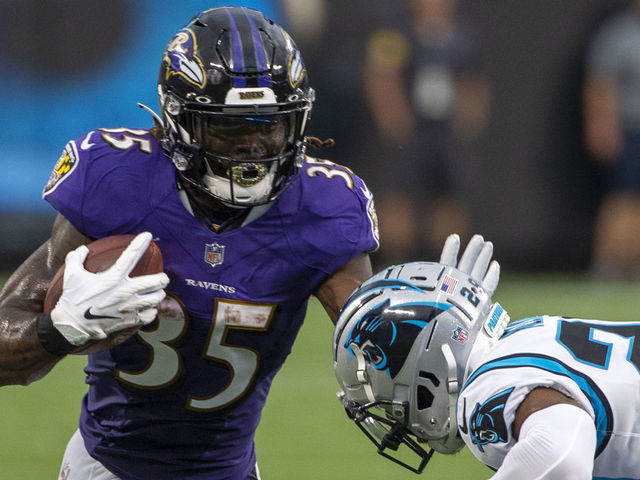 CHARLOTTE, NC - AUGUST 21: Gus Edwards #35 of the Baltimore Ravens runs the ball against the Carolina Panthers during the first half of a NFL preseason game at Bank of America Stadium on August 21, 2021 in Charlotte, North Carolina.