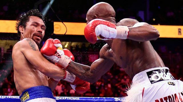 Manny Pacquiao (L) of the Philippines fights against Yordenis Ugas of Cuba during the WBA Welterweight Championship boxing match at T-Mobile Arena in Las Vegas, Nevada on August 21, 2021. - Cuba's Yordenis Ugas upset Manny Pacquiao to retain his WBA welterweight crown on Saturday, winning by unanimous decision after a bruising 12-round battle at the T-Mobile Arena.