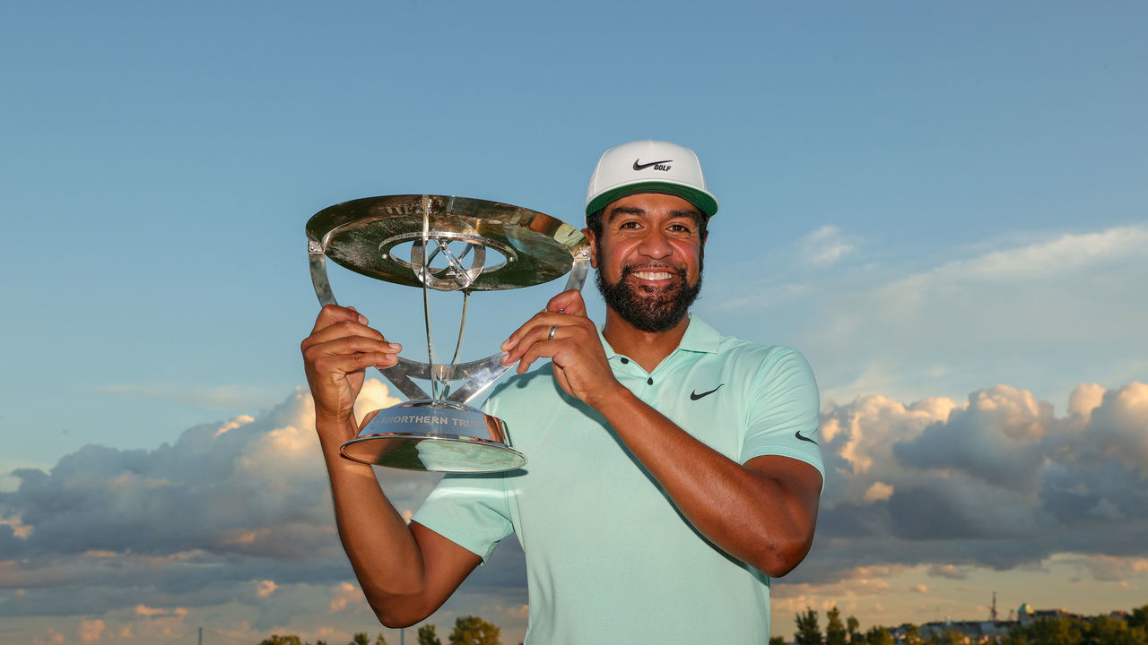 JERSEY CITY, NEW JERSEY - AUGUST 23: Tony Finau of the United States celebrates with the trophy after winning in a playoff during the final round of THE NORTHERN TRUST, the first event of the FedExCup Playoffs, at Liberty National Golf Club on August 23, 2021 in Jersey City, New Jersey.