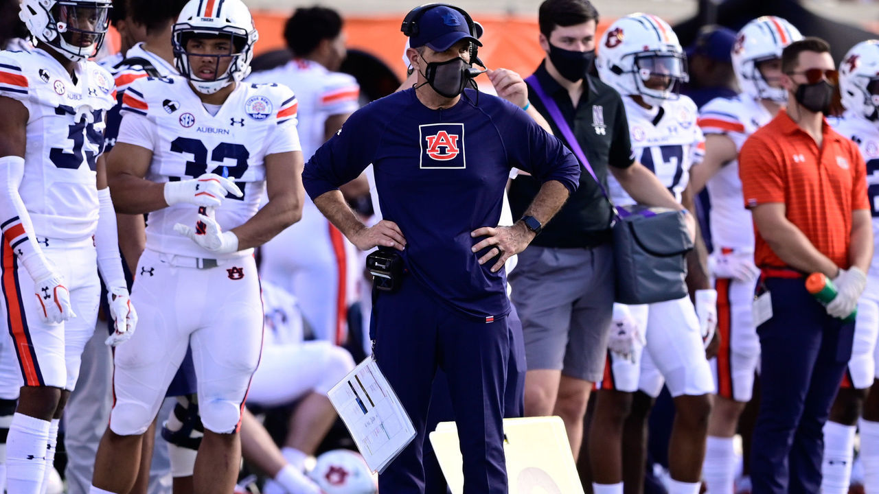 ORLANDO, FL - JANUARY 01: Head coach Bryan Harsin of the Auburn Tigers (blue shirt) looks on during the first half against the Northwestern Wildcats during the Vrbo Citrus Bowl at Camping World Stadium on January 1, 2021 in Orlando, Florida.