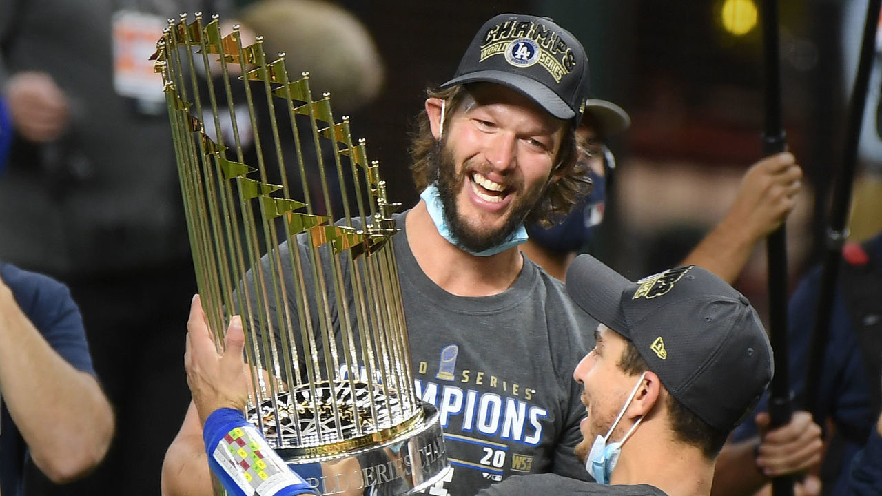 ARLINGTON, TEXAS - OCTOBER 27:Dodgers Clayton Kershaw, left, and Austin Barnes hold the Championship trophy in Game 6 of the World Series at Globe Life Field on October 27, 2020 in Arlington, Texas.