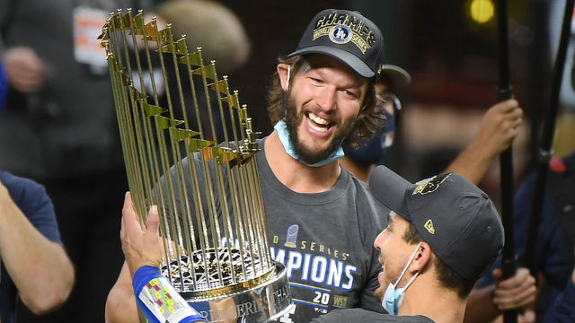 ARLINGTON, TEXAS - OCTOBER 27:Dodgers Clayton Kershaw, left, and Austin Barnes hold the Championship trophy in Game 6 of the World Series at Globe Life Field on October 27, 2020 in Arlington, Texas.