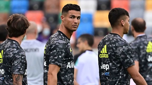 In this photograph taken on August 22, 2021, Juventus' Portuguese forward Cristiano Ronaldo (C) looks on prior to the Italian Serie A football match between Udinese and Juventus at the Dacia Arena Stadium in Udine. - Cristiano Ronaldo will not train with Juventus on August 27, the Serie A giants confirmed to AFP, as rumours of an imminent move to Manchester City gather pace. Widespread media reports said that Ronaldo left Juve's Continassa training centre before the start of Friday's session. Sky Sport Italia reported that the five-time Ballon d'Or winner arrived in the morning to say goodbye to his teammates before leaving at around 10:45 am local time (0845 GMT). Asked by AFP if Ronaldo would be training with his Juve teammates, a club spokeswoman confirmed that he would not.