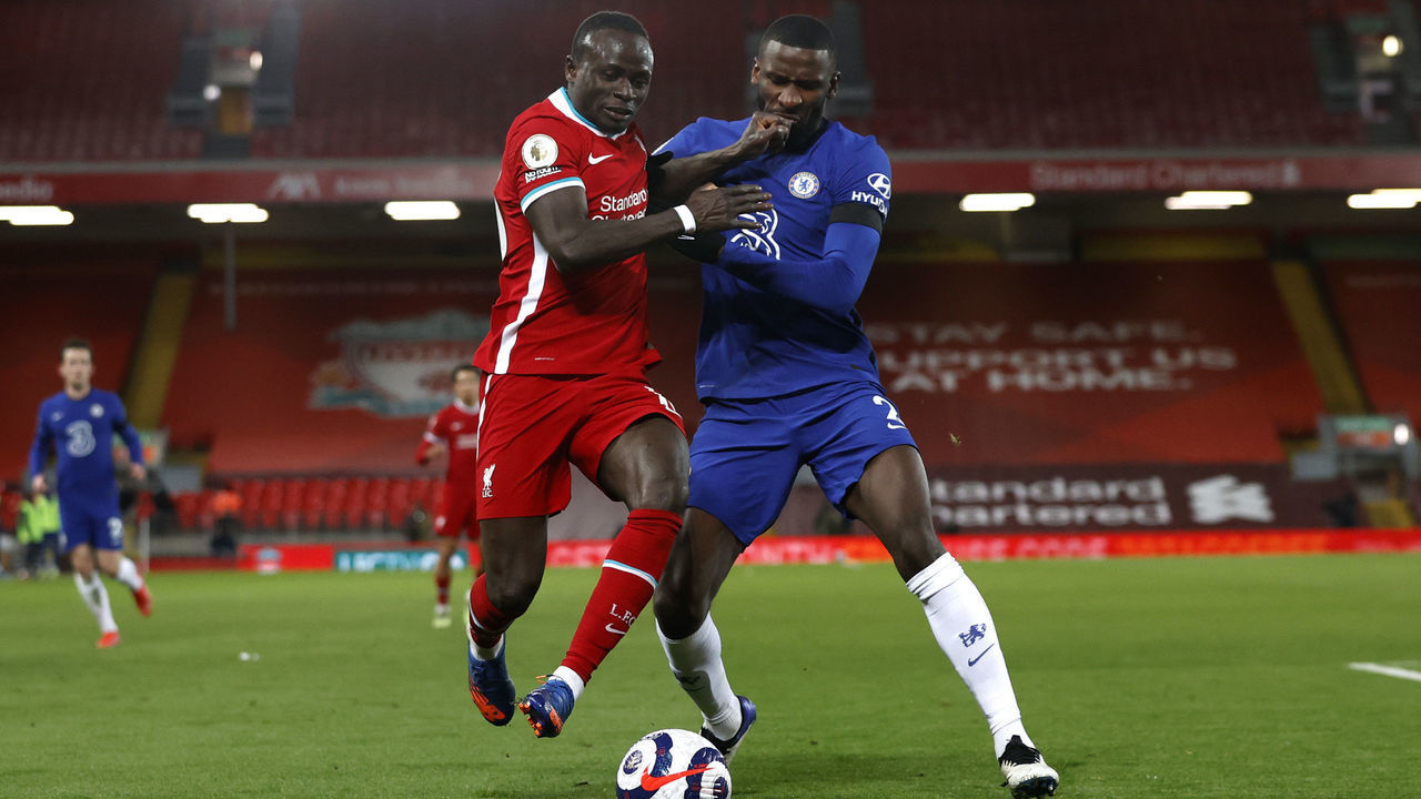LIVERPOOL, ENGLAND - MARCH 04: Sadio Mane of Liverpool battles for possession with Antonio Rudiger of Chelsea during the Premier League match between Liverpool and Chelsea at Anfield on March 04, 2021 in Liverpool, England. Sporting stadiums around the UK remain under strict restrictions due to the Coronavirus Pandemic as Government social distancing laws prohibit fans inside venues resulting in games being played behind closed doors.