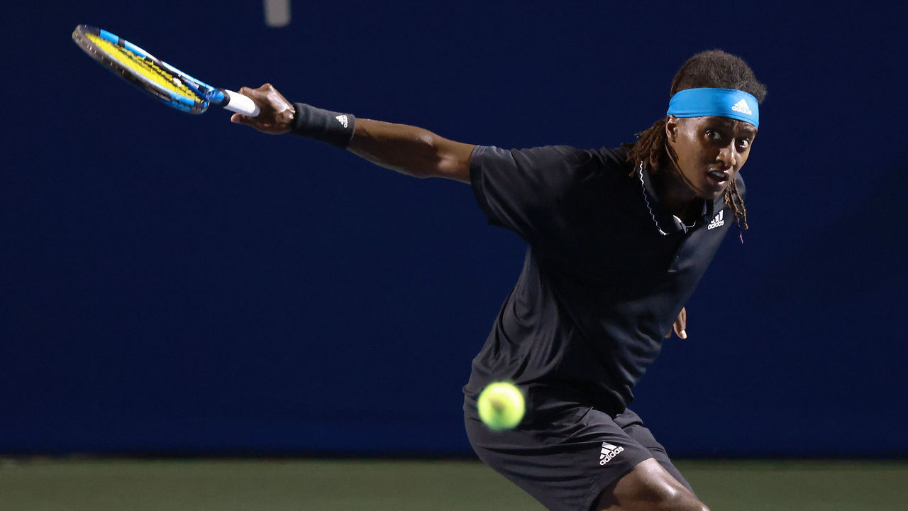 WINSTON SALEM, NORTH CAROLINA - AUGUST 27: Mikael Ymer of Sweden returns a shot to Carlos Alcaraz of Spain during the semifinals of the Winston-Salem Open at Wake Forest Tennis Complex on August 27, 2021 in Winston Salem, North Carolina.