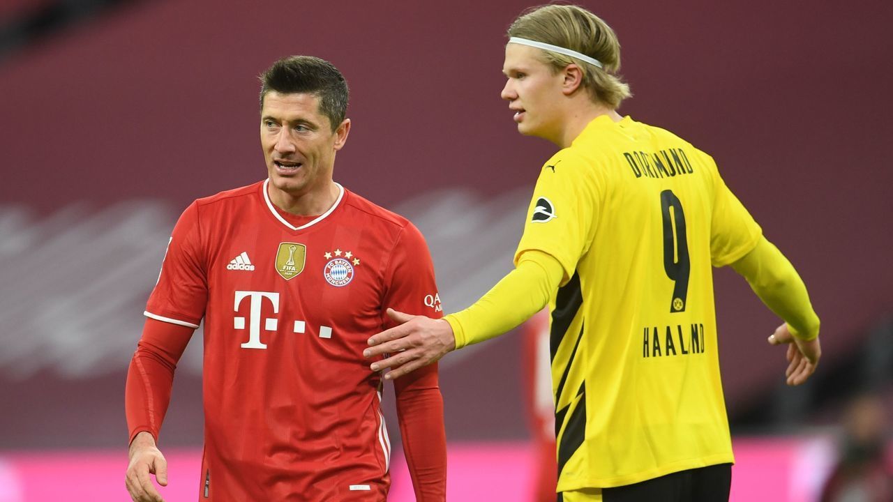 Bayern Munich's Polish forward Robert Lewandowski (L) and Dortmund's Norwegian forward Erling Braut Haaland gesture during the German first division Bundesliga football match between FC Bayern Munich and BVB Borussia Dortmund in Munich, southern Germany, on March 6, 2021.