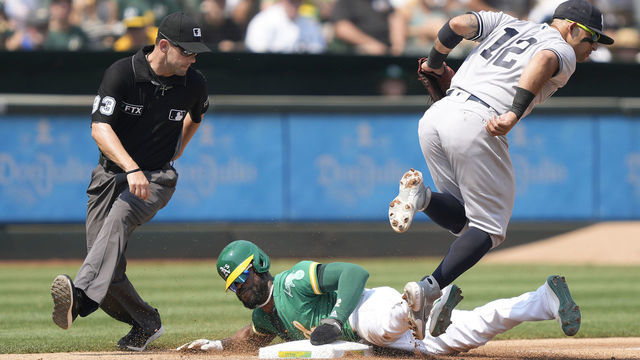 OAKLAND, CALIFORNIA - AUGUST 28: Starling Marte #2 of the Oakland Athletics steals third base sliding in ahead of the tag from Rougned Odor #12 of the New York Yankees in the bottom of the third inning at RingCentral Coliseum on August 28, 2021 in Oakland, California.