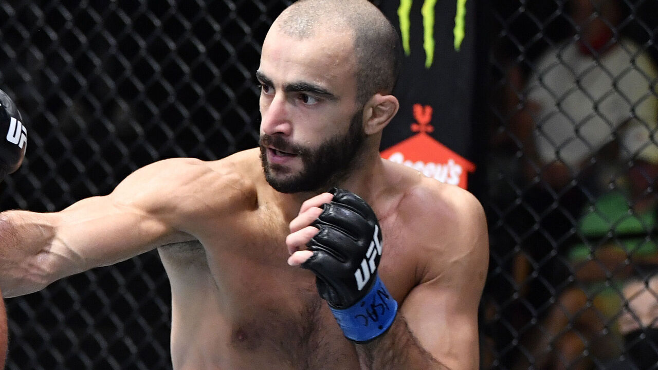 LAS VEGAS, NEVADA - AUGUST 28: (R-L) Giga Chikadze of Georgia punches Edson Barboza of Brazil in a featherweight fight during the UFC Fight Night event at UFC APEX on August 28, 2021 in Las Vegas, Nevada.