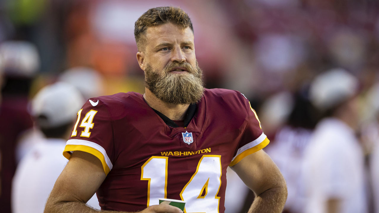 LANDOVER, MD - AUGUST 28: Ryan Fitzpatrick #14 of the Washington Football Team looks on from the sidelines during the first half of the preseason game against the Baltimore Ravens at FedExField on August 28, 2021 in Landover, Maryland.