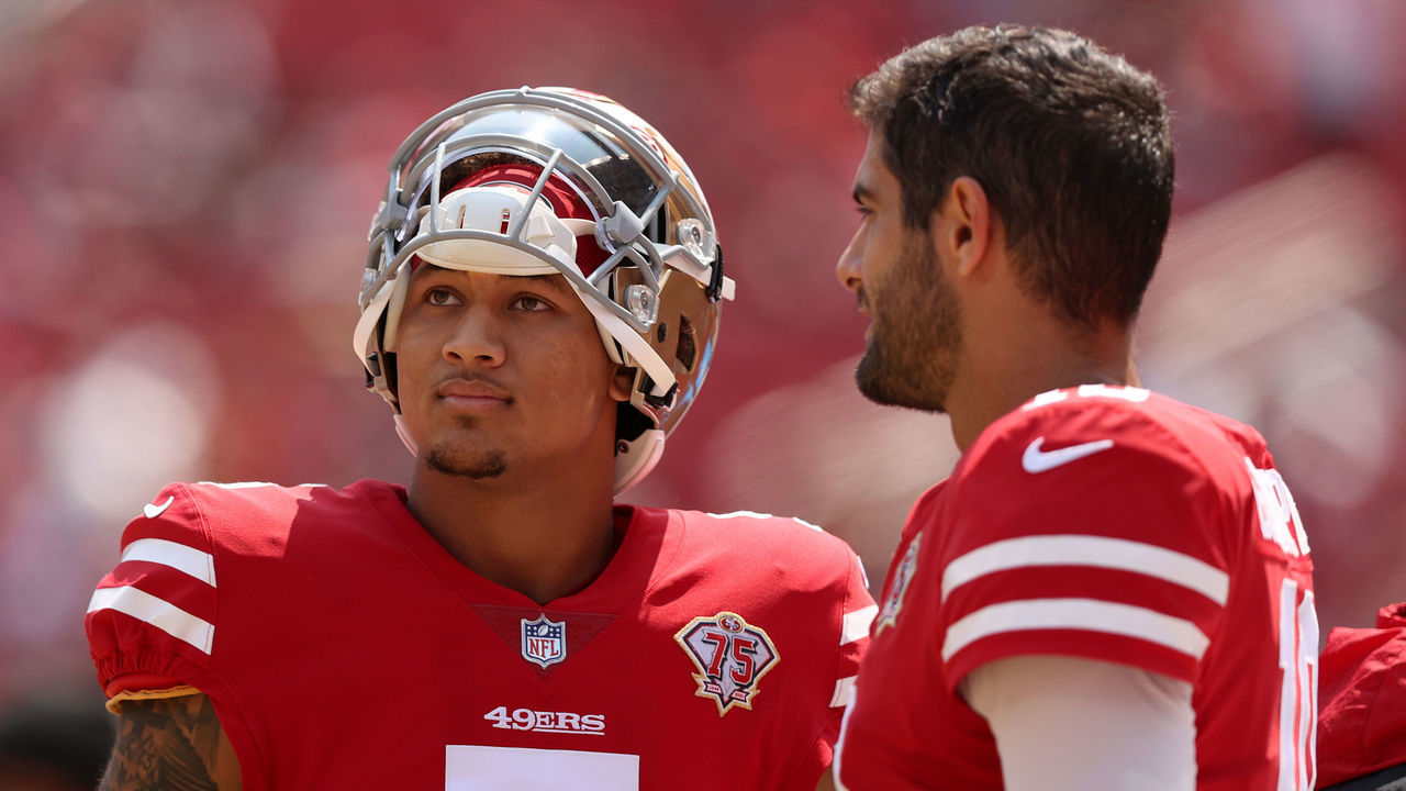 SANTA CLARA, CALIFORNIA - AUGUST 29: Jimmy Garoppolo #10 and Trey Lance #5 of the San Francisco 49ers talk to each other on the sidelines before their preseason game against the Las Vegas Raiders at Levi's Stadium on August 29, 2021 in Santa Clara, California.