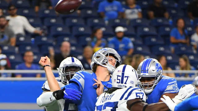 DETROIT, MI - AUGUST 27: Detroit Lions quarterback Tim Boyle (12) is hit by Indianapolis Colts defensive end Kwity Paye (51) has hes passing and fumbles during the Detroit Lions vs Indianapolis Colts preseason game on Friday August 27, 2021 at Ford Field in Detroit, MI.
