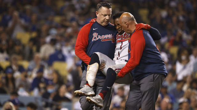 LOS ANGELES, CALIFORNIA - AUGUST 31: Ozzie Albies #1 of the Atlanta Braves reacts to an apparent injury while being carried off the field during a game against the Los Angeles Dodgers the fifth inning at Dodger Stadium on August 31, 2021 in Los Angeles, California.