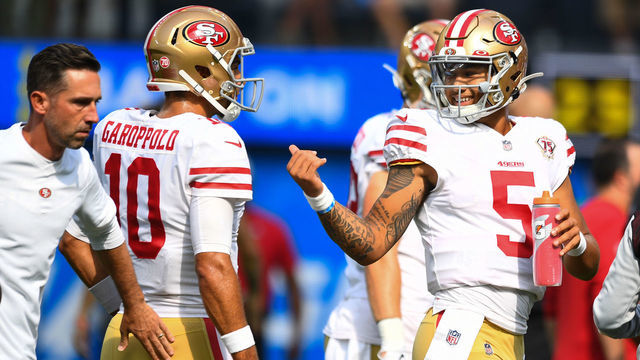 INGLEWOOD, CA - AUGUST 22: San Francisco 49ers head coach Kyle Shanahan slaps San Francisco 49ers quarterback Jimmy Garoppolo (10) as he talks with quarterback Trey Lance (5) before the NFL preseason game between the San Francisco 49ers and the Los Angeles Chargers on August 22, 2021, at SoFi Stadium in Inglewood, CA.