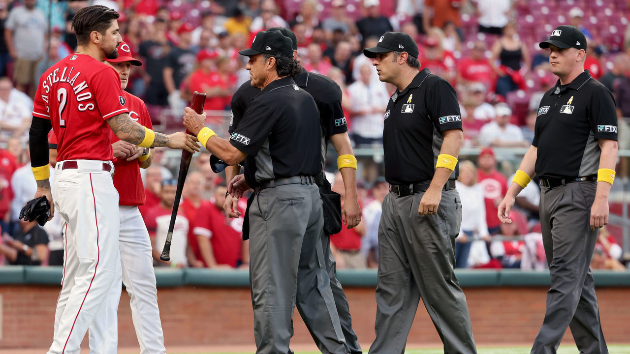 CINCINNATI, OHIO - SEPTEMBER 01: Umpire Phil Cuzzi inspects the bat used by Nick Castellanos #2 of the Cincinnati Reds in the second inning against the St. Louis Cardinals during game two of a doubleheader at Great American Ball Park on September 01, 2021 in Cincinnati, Ohio.