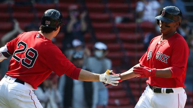 BOSTON, MA - APRIL 24: Rafael Devers #11 celebrates with teammate Bobby Dalbec #29 of the Boston Red Sox after scoring off of a single by Marwin Gonzalez in the seventh inning against the Seattle Mariners at Fenway Park on April 24, 2021 in Boston, Massachusetts.