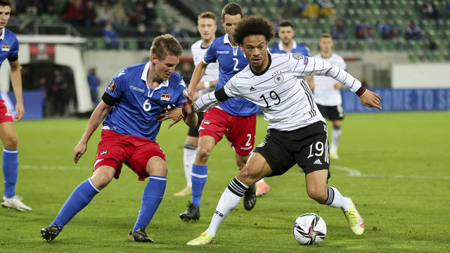 ST GALLEN, SWITZERLAND - SEPTEMBER 02: (BILD OUT) Andreas Malin of Liechtenstein and Leroy Sane of Germany battle for the ball during the 2022 FIFA World Cup Qualifier match between Liechtenstein and Germany at Kybunpark on September 2, 2021 in St Gallen, Sankt Gallen.