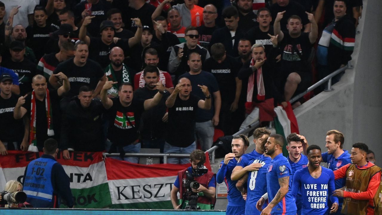 Hungary's fans react as England's team celebrates the 0-1 during the FIFA World Cup Qatar 2022 qualification Group I football match between Hungary and England, at the Puskas Arena in Budapest on September 2, 2021.