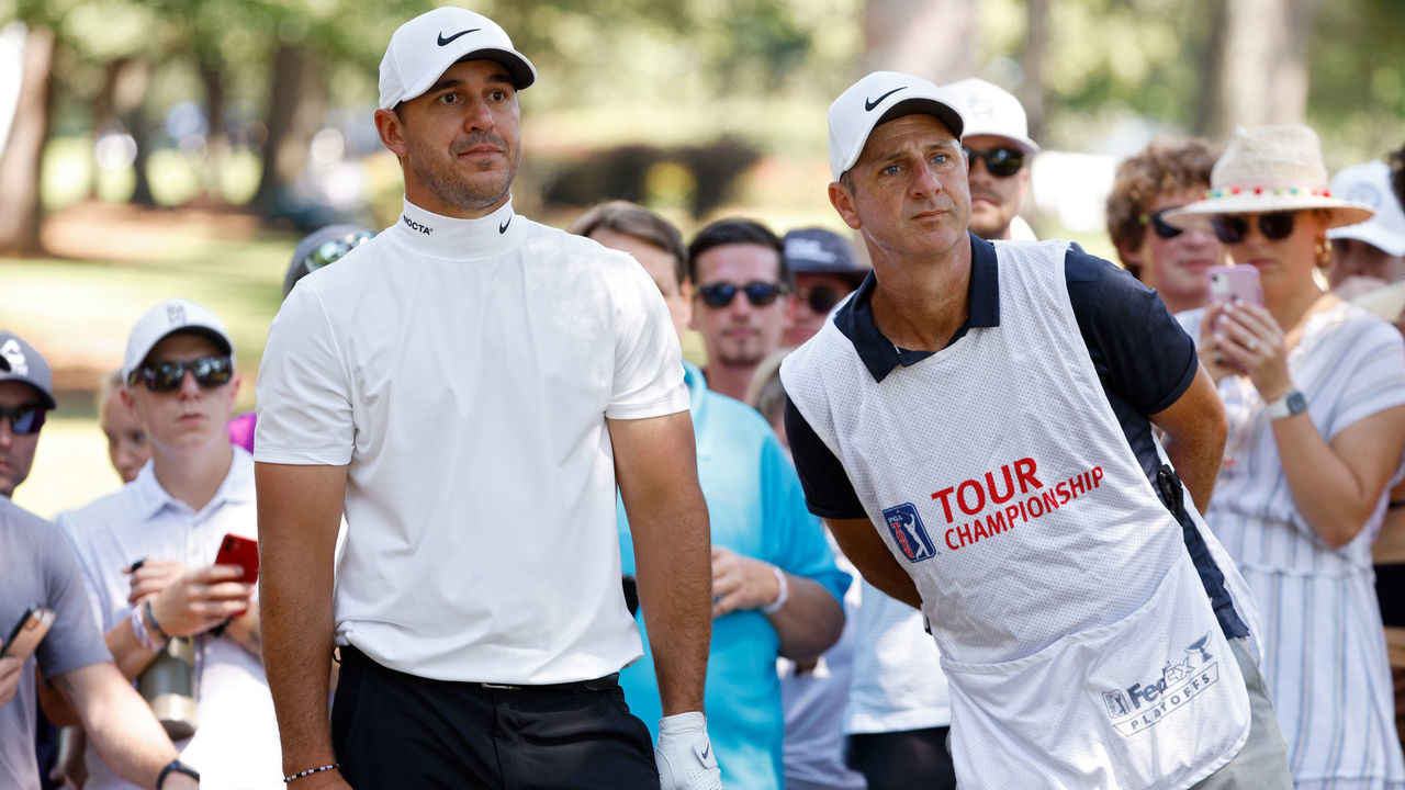 ATLANTA, GEORGIA - SEPTEMBER 04: Brooks Koepka and his caddie line up a shot on the seventh hole during the third round of the TOUR Championship at East Lake Golf Club on September 04, 2021 in Atlanta, Georgia.