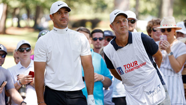 ATLANTA, GEORGIA - SEPTEMBER 04: Brooks Koepka and his caddie line up a shot on the seventh hole during the third round of the TOUR Championship at East Lake Golf Club on September 04, 2021 in Atlanta, Georgia.