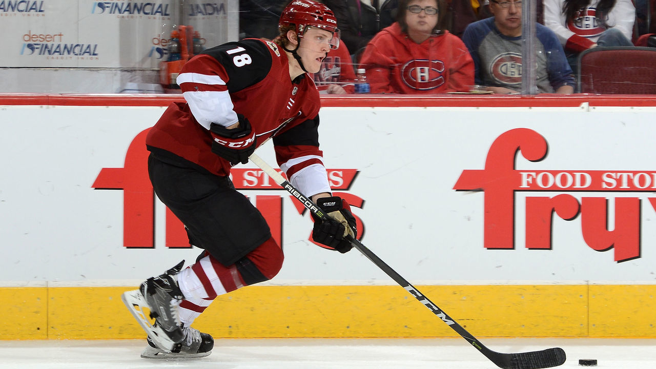GLENDALE, AZ - FEBRUARY 15: Christian Dvorak #18 of the Arizona Coyotes skates with the puck against the Montreal Canadiens at Gila River Arena on February 15, 2018 in Glendale, Arizona.