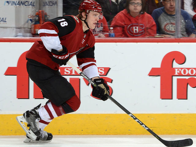 GLENDALE, AZ - FEBRUARY 15: Christian Dvorak #18 of the Arizona Coyotes skates with the puck against the Montreal Canadiens at Gila River Arena on February 15, 2018 in Glendale, Arizona.