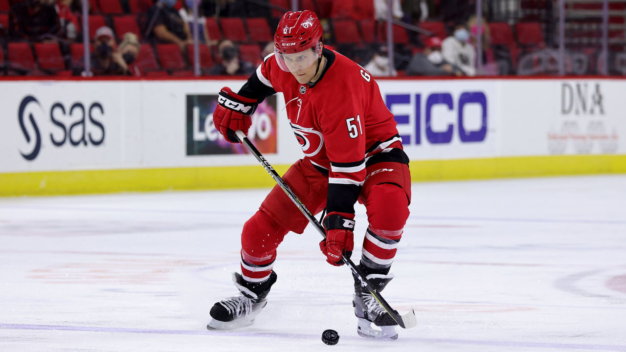 RALEIGH, NC - APRIL 12: Jake Gardiner #51of the Carolina Hurricanes controls a puck near the blufeline during an NHL game against the Detroit Red Wings on April 12, 2021 at PNC Arena in Raleigh, North Carolina.