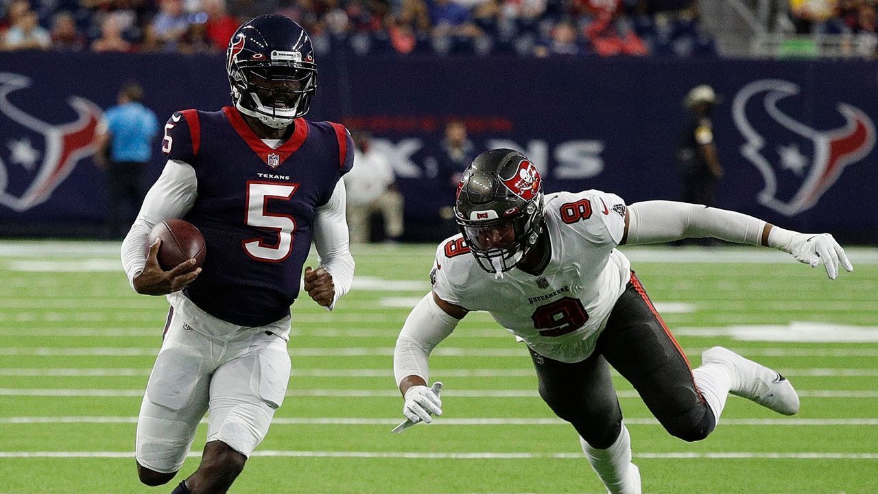 HOUSTON, TEXAS - AUGUST 28: Tyrod Taylor #5 of the Houston Texans avoids a tackle attempt by Joe Tryon-Shoyinka #9 of the Tampa Bay Buccaneers in the first half during a NFL preseason game at NRG Stadium on August 28, 2021 in Houston, Texas.