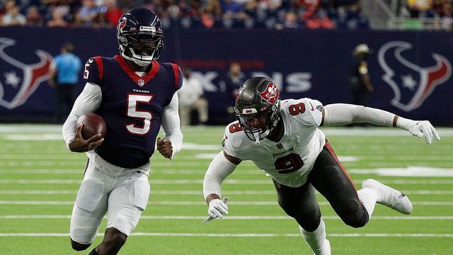 HOUSTON, TEXAS - AUGUST 28: Tyrod Taylor #5 of the Houston Texans avoids a tackle attempt by Joe Tryon-Shoyinka #9 of the Tampa Bay Buccaneers in the first half during a NFL preseason game at NRG Stadium on August 28, 2021 in Houston, Texas.