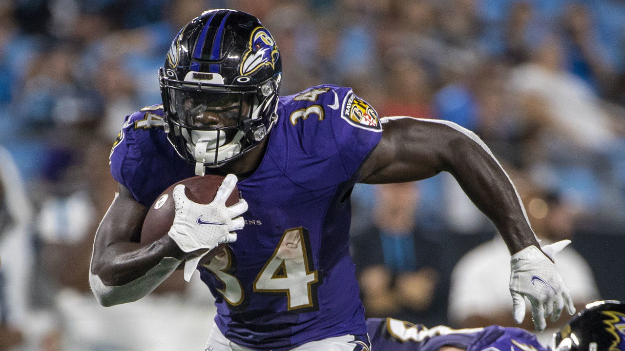 CHARLOTTE, NC - AUGUST 21: Ty'Son Williams #34 of the Baltimore Ravens runs the ball against the Carolina Panthers during the second half of a NFL preseason game at Bank of America Stadium on August 21, 2021 in Charlotte, North Carolina.