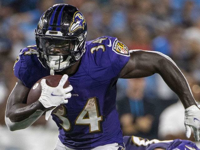 CHARLOTTE, NC - AUGUST 21: Ty'Son Williams #34 of the Baltimore Ravens runs the ball against the Carolina Panthers during the second half of a NFL preseason game at Bank of America Stadium on August 21, 2021 in Charlotte, North Carolina.