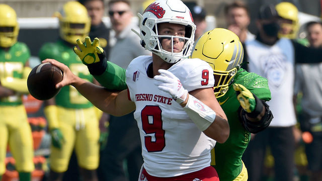 EUGENE, OREGON - SEPTEMBER 04: Quarterback Jake Haener #9 of the Fresno State Bulldogs is sacked by defensive end Kayvon Thibodeaux #5 of the Oregon Ducks during the first quarter of the game at Autzen Stadium on September 04, 2021 in Eugene, Oregon.